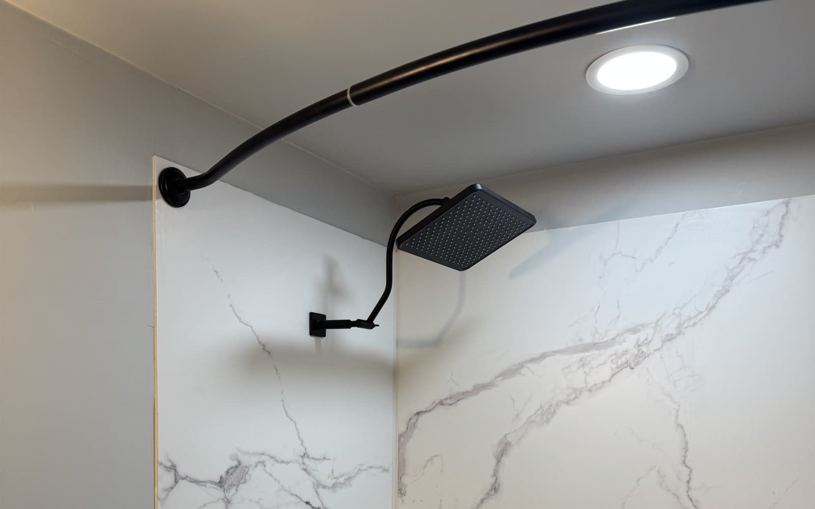 Renovated shower with a dark shower fixture